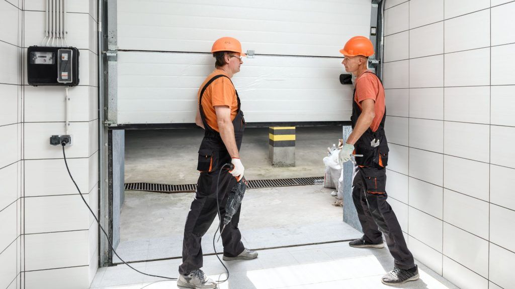 Man Orange Shirt White Garage Door